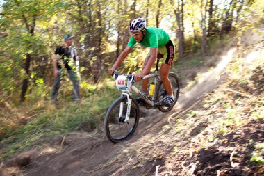 Mountain bike competition in autumn forest clipart