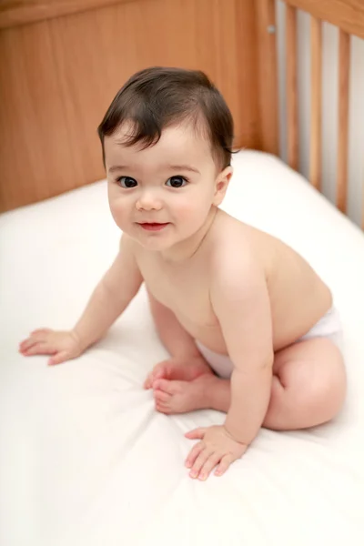 Beautiful baby in his cot — Stock Photo, Image