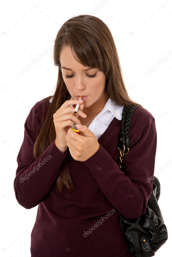 Young woman lighting cigarette