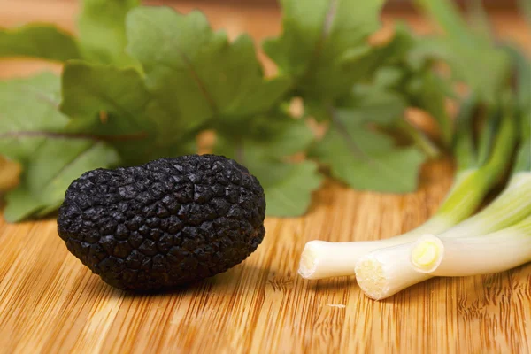 stock image Black truffle on wooden background