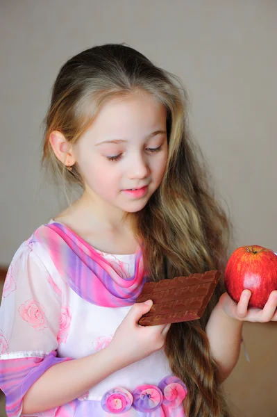 stock image The girl with an apple and chocolate