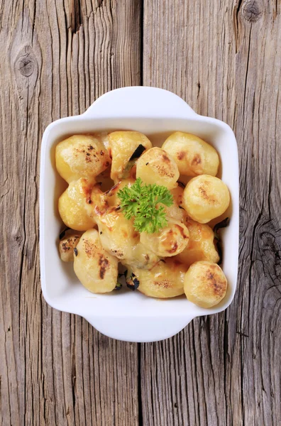 Cheese coated potatoes — Stock Photo, Image