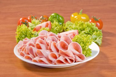 Slices of Mortadella salami clipart