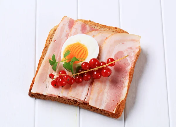 Slice of bread with bacon — Stock Photo, Image