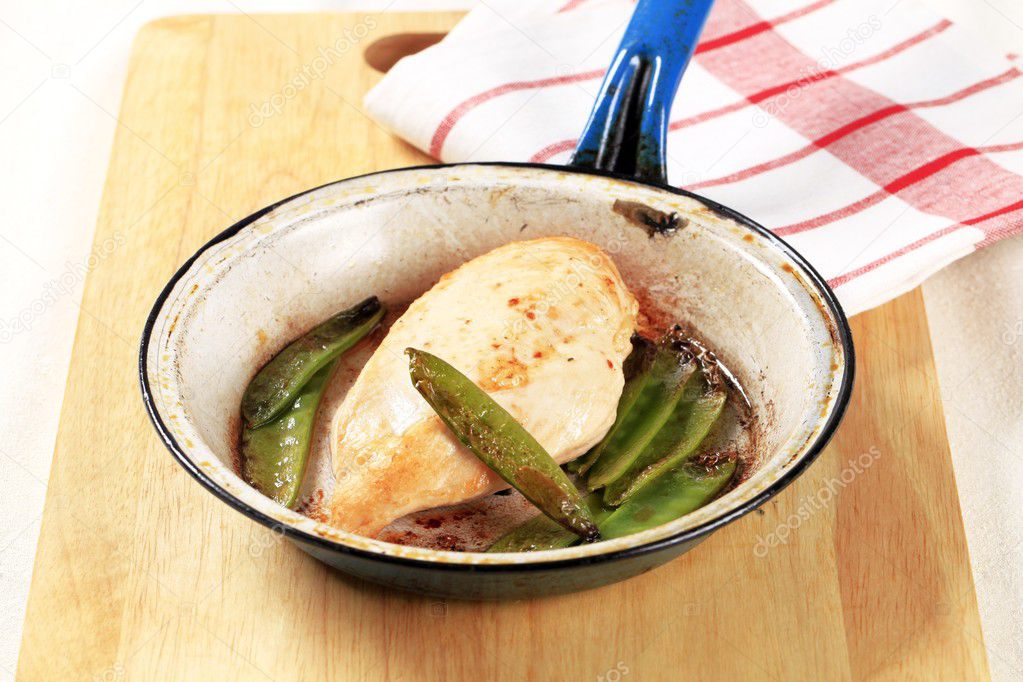 Pan fried chicken fillet and snow peas