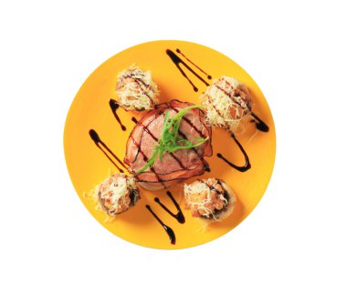 Mushrooms stuffed with ground meat and bacon-wrapped pork fillet clipart