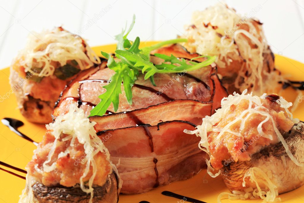 Mushrooms stuffed with ground meat and bacon-wrapped pork fillet