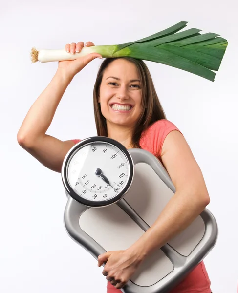 Young woman holding a scale and fresh vegetable — Stock Photo, Image