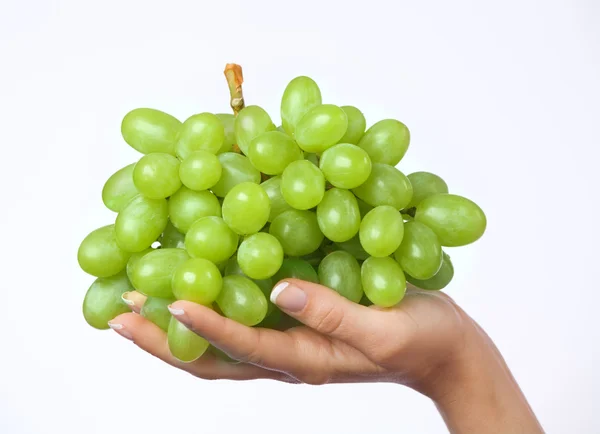 Woman's hand holding a bunch of fresh grapes