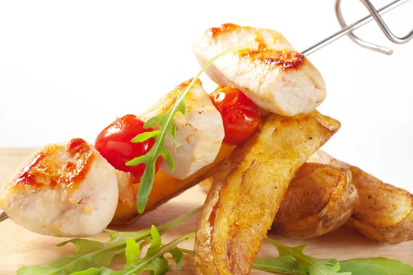 Chicken skewer and potato wedges Stock Photo