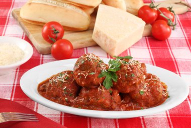 Italian meatballs in an oval dish. clipart