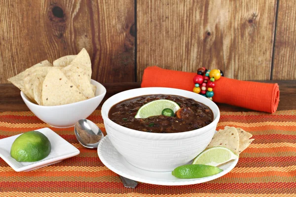 Black bean mexican soup with chips and lime. — Stock Photo, Image
