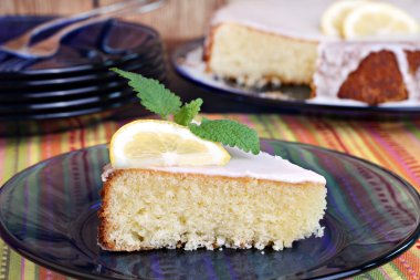 Lemon cake garnished with a slice of lemon and lemon mint. clipart