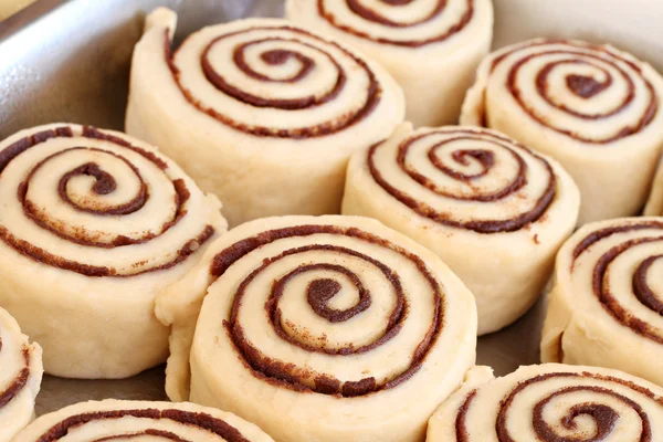 Raw cinnamon buns ready to bake with selective focus. — Stock Photo, Image