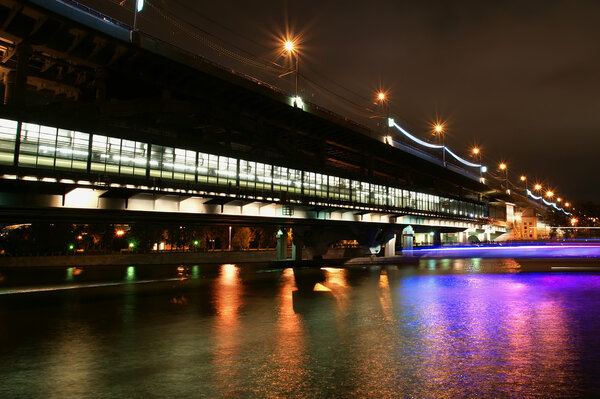 Moscow River, Luzhnetskaya Bridge (Metro Bridge) in the light of night colored lights. Moscow, Russia