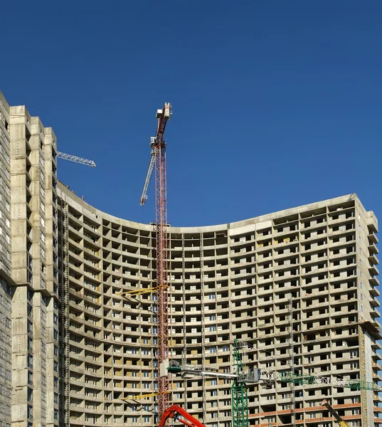 Grúa de construcción en el fondo del edificio en construcción — Foto de Stock