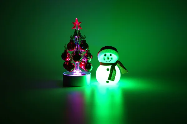 Glowing from within snowman and Christmas tree — Stock Photo, Image