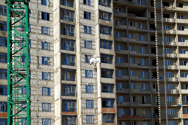 stock image Building crane at the background of building under construction