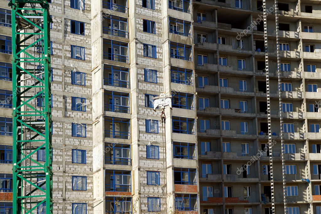 Building crane at the background of building under construction Stock ...