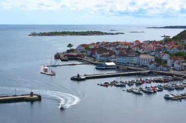 Motorboat Entering the Harbor of Risor, Norway clipart