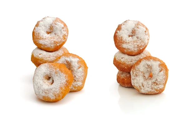 stock image Fried donuts in powdered sugar on a white background