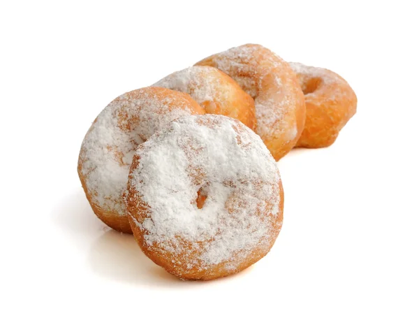 Fried donuts in powdered sugar on a white background — Stock Photo, Image