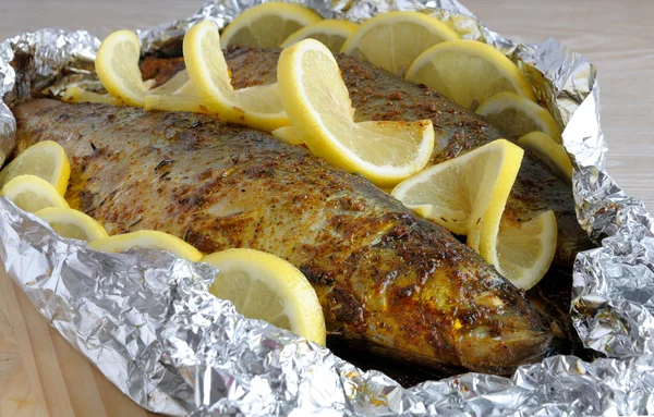 stock image Baked herring in spices and herbs in foil