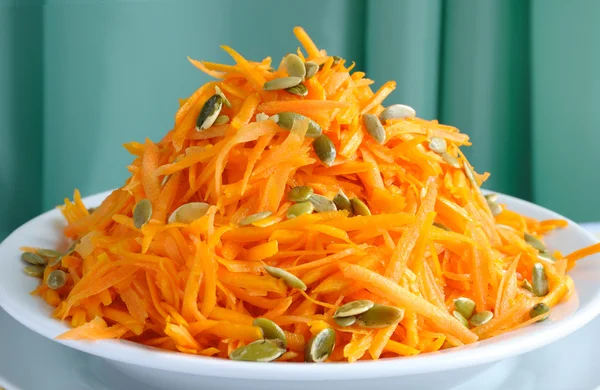Salad of pumpkin and carrot with pumpkin seeds — Stock Photo, Image