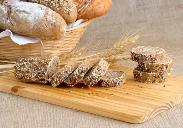 Diverse bread with slices of bread with grains — Stock Photo, Image