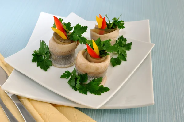 Rolls of herring with pickled cucumber and pepper — Stock Photo, Image