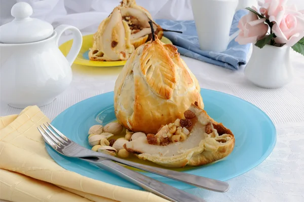 Stuffed with a mixture of nuts and raisins pear in puff pastry — Stock Photo, Image