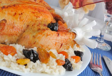 A fragment of grilled chicken with rice and dried fruit clipart