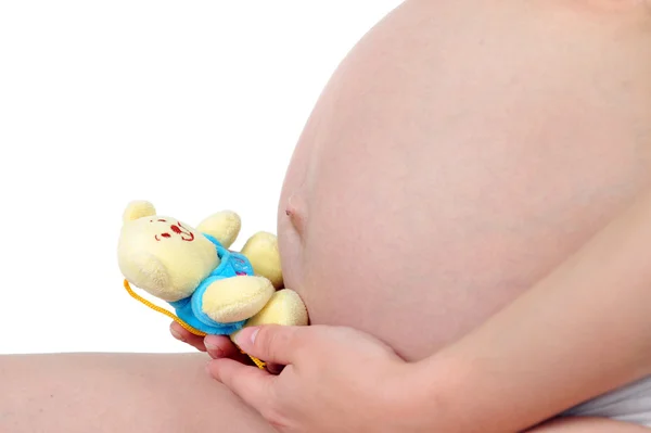 Femme enceinte avec jouet d'enfant — Photo