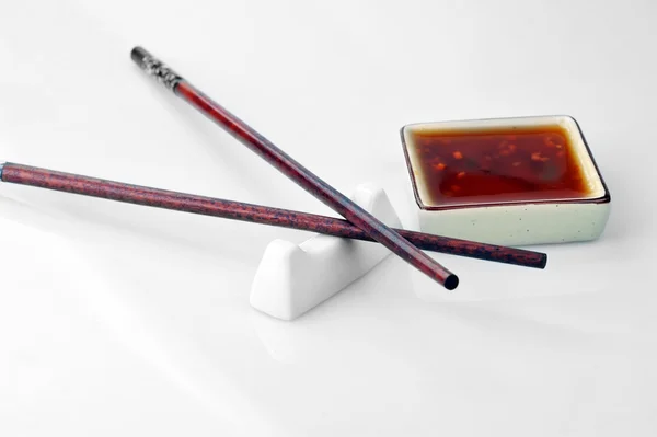 Chopsticks and bowl with sauce — Stock Photo, Image