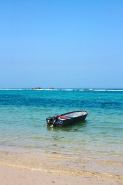 Boat in caribbean beach. Tayrona National Park. Colombia clipart