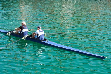 Two grandparents do water sports. clipart