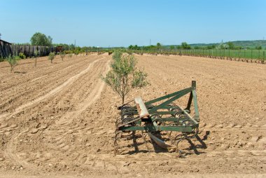 Countryside View of Furrowed Farmland with prairie breaker clipart