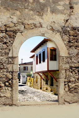 Traditional greek house through an old door, Greece clipart