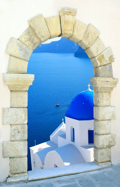 Traditional greek church through an old window in Santorini island, Greece — Stock Photo, Image