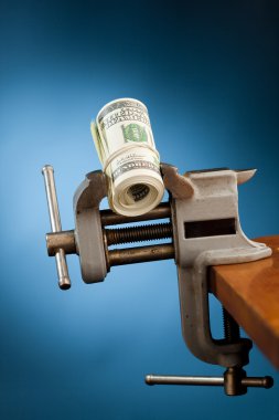 Low budget concept - money in the vice tool clipart