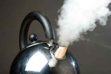 Boiling kettle with dense steam clipart