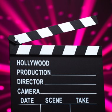 Clapperboard on shiny background clipart