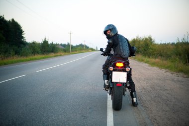 Motorcyclist on the roadside clipart