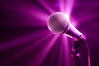 Microphone on stage with purple background clipart