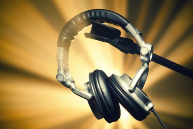 Headphones on shiny background clipart