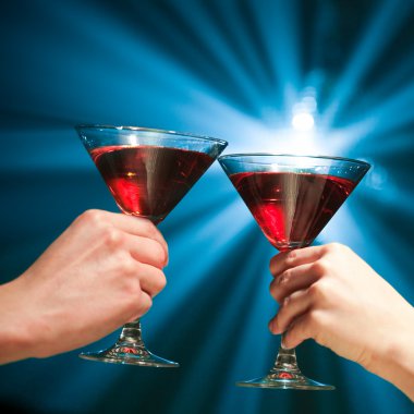 Pair of martini glasses making a toast clipart