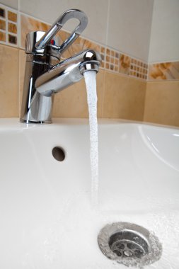 Mixer tap with running water clipart