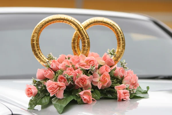 stock image Wedding rings on the car with beautiful bunch of flowers