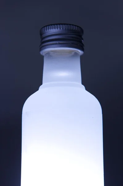 Tres botellas de vidrio con iluminación de colores —  Fotos de Stock