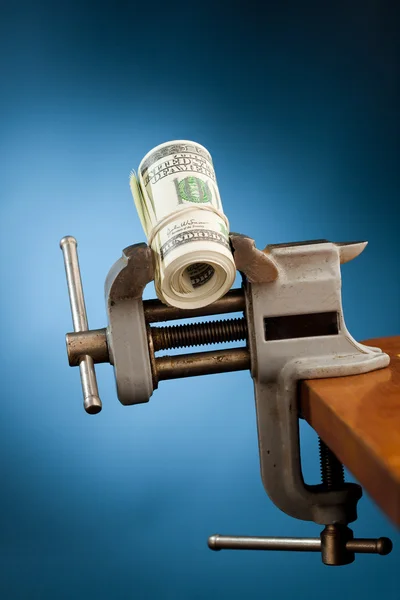 Low budget concept - money in the vice tool — Stock Photo, Image